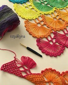 the crochet is being used to make an embroidered piece with yarn and thread