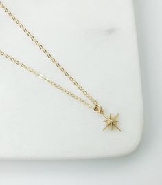 dainty gold necklace, gift for women, star necklace, Celestial jewelry, Dainty jewelry, Gold necklace, simple necklace, starburst necklace Gold North star necklace. The perfect everyday piece. Layer it or wear it solo. MADE TO LAST: * Gold filled cable Chain with gold filled spring ring clasp closure. *Matte Gold plated star charm approx 10mm x 10mm *Chose your perfect length SHIPPING: Free domestic shipping on all orders PACKAGING All pieces come beautifully packaged, perfect for gift giving. F Dainty Yellow Gold Star Charm Necklace, Delicate Yellow Gold Star Necklace, Dainty 14k Gold Star Charm Jewelry, Dainty 14k Gold Filled Star Charm Necklaces, Dainty 14k Gold Filled Star Charm Necklace, 14k Gold Dainty Jewelry With Star Charm, Delicate Star-shaped Yellow Gold Necklace, Delicate Yellow Gold Star Charm Necklace, Dainty Star Of David Jewelry With Adjustable Chain