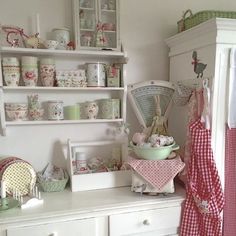 a white dresser topped with lots of dishes