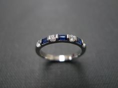 A wedding band set with diamond and emerald cut blue sapphire made in 14k white gold. Product Specifications: Type: 3 Radiant/Emerald cut Natural Blue Sapphire Type: 4 Round Brillant Cut Diamond with total carat weight of 0.12cttw Quality: D-F in Color and VS with Heart and Arrow (Ideal cut) Precious Metal: 14K White Gold Ring Width: Approx. 2.2mm Currently made to order pieces may take up to 10 business days to complete, or let me know if you need it urgent. You may also like: A similar ring ma Emerald Cut Sapphire Ring With Channel Set For Anniversary, Wedding Sapphire Ring Channel Set Baguette Cut, Wedding Sapphire Ring, Baguette Cut With Channel Set, Blue Sapphire Ring With Single Cut Diamonds For Wedding, Blue Diamond Ring With Single Cut Diamonds For Wedding, Blue Wedding Ring With Single Cut Diamonds, White Gold Channel Set Sapphire Ring For Wedding, Rectangular Brilliant Cut Sapphire Ring For Wedding, Sapphire Diamond Ring Channel Set For Wedding