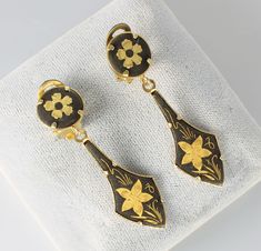 Lovely 1960s Spain Toledo Damascene earrings. They display beautiful chased flower work in a striking black and gold contrast. Length is 1 7/8 inches and width is 1/2 inch. In very good vintage condition! Vintage Black Enamel Earrings For Gifts, Vintage Gold Clip-on Earrings With Black Enamel, Spain Toledo, Catholic Rosary Bracelet, 1950s Jewelry, 1960s Jewelry, Spartanburg Sc, Faux Pearl Earrings, Rosary Bracelet