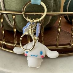 a keychain with a cartoon character hanging from it's side on a table