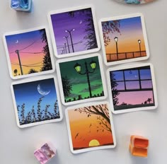 four different cards with pictures of trees and street lights on them next to some gummy cubes