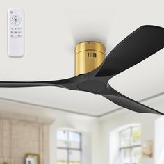 a black and gold ceiling fan with remote control