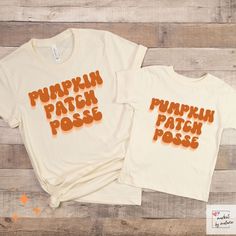 Get ready to make unforgettable memories this Halloween season with our "Pumpkin Patch Posse" Family T-Shirts. These delightful matching shirts feature a playful design with a jack-o-lantern and the phrase "Pumpkin Patch Posse," perfect for creating a unified and festive look for the whole family.  Sizes for the Whole Family: We offer a wide range of sizes to accommodate every member of your family, from the littlest pumpkins to the adults. Choose from infant, toddler, kids, and adult sizes to e Family Matching Short Sleeve Tops For Fall, Orange Cotton Tops For Halloween, Orange Cotton Shirt For Halloween, Group Halloween Shirts, Family T Shirts, Class Shirt, Room Mom, Patches Shirt, Matching Halloween