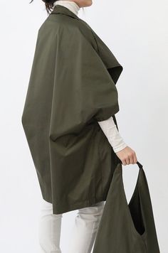 Designed with room to layer, meet the Guilia Rain Shell Coat. This oversized asymmetrical zip coat is unconventionally chic in a one-size, all-weather water-repellant design. Bring in a Goose Down thermal layer under this coat or simply add a soft sweater this season. Finish your style with a pair of boots and a fitted pant and you're ready for anything the sky throws at you. Size Guide and Fit One size fits most design Designed for an oversized to loose-fitting style. Made to easily layer under Zip Coat, High Neck Designs, Black Quartz, Fern Green, Rain Coat, Soft Sweater, Water Repellent Fabric, New Launch, Softest Sweater