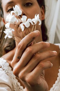 a close up of a person holding flowers in their hands