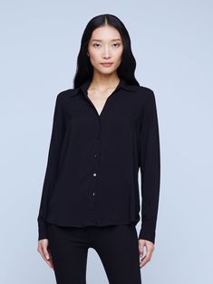 A modern classic. The Nina blouse is structured in all the right places with a relaxed, flattering fit. Refined button-down construction with a chic open collar and draped long sleeve in black silk. Modern Spread Collar Blouse For Business Casual, Versatile Formal Blouse With Button Closure, Modern Business Casual Blouse With Spread Collar, Modern Blouse For Business, Semi-formal Sleek Collared Blouse, Modern Blouse With Lapel Collar For Office, Semi-formal Sleek Blouse With Spread Collar, Sleek Spread Collar Blouse For Work, Sleek Blouse With Spread Collar For Work