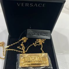 New $450 Versace Gold Tone Brass License Registration Plate Logo Charm Necklace Size(S) Length 59 Cm, About 23" Description New With Tag And Box. Purchased From Versace. Retail $450. Photos Are Of The Actual Item. Authentic Versace Necklace In A Whimsy Style. Gold Tone Brass Curb Chain. Featuring A License Plate Style Print Stating "Versace Forever Italy" And "Spring/Summer 20". Classic Lobster Clasp. Medusa Charm With Versace Hallmark On The Back. Style Dg18036. Made In Italy. Great Collectors Luxury Gold Jewelry With Logo Charm, Luxury Evening Necklaces With Chain Detail, Elegant Formal Chain Necklace With Logo Charm, Luxury Evening Necklace With Chain Detail, Luxury Evening Necklace With Chain, Designer Chain Necklaces For Formal Occasions, Formal Gold Chain Necklace With Logo Charm, Designer Gold Necklaces For Evening, Luxury Gold Jewelry With Gold-tone Logo Plaque