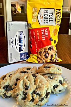 chocolate chip cookies and milk are on the table next to a bag of house made biscuits