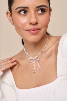 Everyone will bow down to your cute aesthetic when you wear the Lulus Sweetest Potential Clear Beaded Bow Choker Necklace! This adorable necklace features shiny, iridescent clear beads (in varying sizes) that form a choker silhouette that boasts an oversized bow detail at the center. Gold hardware throughout. Lobster clasp closure. Chain measures 11. 75" Long. Extender chain 3" long. 100% Acrylic. Imported. Lulus | Sweetest Potential Clear Iridescent Beaded Bow Choker Necklace. Clear Necklace, Bow Choker, Beaded Bow, Traditional Engagement Rings, Clear Beads, Basic Jewelry, Bow Necklace, Bow Jewelry, Photoshoot Inspo