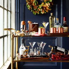 a bar cart filled with glasses and drinks