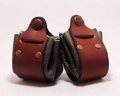 100% Handmade, Genuine Leather Drawstring Pouch. Perfect for Renaissance Fairs, DnD dice pouches, coin purses, or whatever else you want to hold! This drawstring pouch can comfortably hold 1 full sets of average sized TTRPG dice (d4, d6, d8, d10, d12, d20, d100s).  Genuine leather is used for the pouch, band, and drawstring; rivets are made from antiqued copper. Only 11 pieces available:  3 light gray pouches 4 dark gray pouches 4 brown-gray pouches These pieces are limited! The redwood leather used for the bands is no longer available from my source. No machinery was used in the making of this pouch-it is completely made by hand. Brown Pouch With Coin Pocket As Gift, Brown Bags With Snap Closure For Gift, Pouch Bags With Snap Closure As Gift, Gift Pouch Bag With Snap Closure, Leather Coin Purse With Snap Closure As Gift, Leather Coin Purse With Snap Closure For Gift, Handmade Brown Coin Purse Pouch, Handmade Brown Coin Purse For Personal Use, Handmade Brown Coin Purse