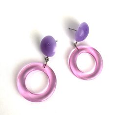 lLight pink donut hoops with lilac purple moonglow lucite studs. Geometric lucite earrings made with vintage parts. Mod meets 80's opulence. Measures just under 2" from top to bottom, super light weight with just enough swing to make a statement. Earrings are made with vintage lucite parts that were made in the US in the 1960's - early 80's. We hand-set them with surgical steel earring posts and they have sturdy surgical steel/acrylic backings on them as well. Modern Pink Hoop Earrings, Trendy Purple Plastic Jewelry, Trendy Purple Round Earrings, Lucite Earrings, 70s Jewelry, Pink Donut, 80s Earrings, Slouch Socks, Diy Resin Projects