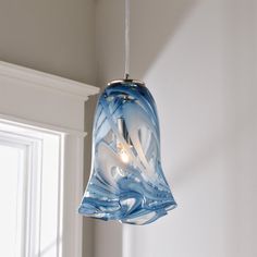 a blue glass light hanging from a ceiling