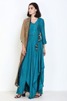 Turquoise angarakha kurta with mirror work and asymmetrical hem. Comes with churidar and embroidered dupatta.
Component: 3
Pattern: Embroidery
Type Of Work: Thread and Mirror
Neckline: V neck
Sleeve Type: Three Fourth
Fabric: Slub Muslin
Color: Blue
Other Details: 
Dupatta with embroidery and tassel detail
Button tabs on the sleeves
Tie up on the side
Occasion: Wedding - Aza Fashions Anarkali Long Sleeve Pre-draped Saree For Diwali, Fitted Anarkali Handloom Kurta, Anarkali Style Designer Handloom Palazzo Set, Traditional Transitional Pre-draped Saree With Long Sleeves, Traditional Long Sleeve Pre-draped Saree For Transitional Season, Traditional Long Sleeve Pre-draped Saree, Handloom Anarkali Kurta With Long Sleeves, Anarkali Handloom Kurta With Long Sleeves, Designer Kurta With Asymmetrical Hem For Eid