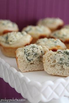 small cupcakes with blue cheese and spinach on a white cake platter