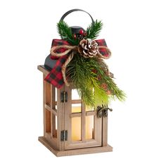 a wooden lantern with a christmas decoration on the top and a pine cone hanging from it