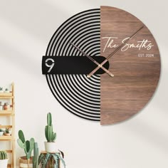 a wooden clock with the words, the smiths on it and a black ribbon