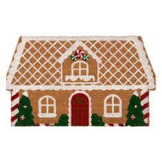 a door mat with a gingerbread house on it