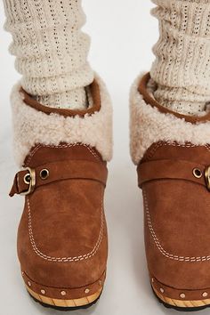 A timeless style goes cozy with these sherpa-adorned clog boots, sat on a wood platform sole and finished with fuzzy panels and buckle detailing. **Features:** Low-ankle length, suede uppers, round toe, seamed details, buckle strap detail, tacked accents, platform wood sole, rubber outsole, sherpa panels and lining **Why We | Oak Clog Boots by FP Collection at Free People in Tan, Size: US 9 Clog Boots, Tan Suede, Timeless Style, Black Suede, Ankle Length, Timeless Fashion, Clogs, Free People, Buckle