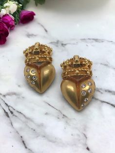 We are loving these uniquely designed earrings! Earring Details Material: 18K Yellow Gold Weight: 18.0 Grams Length: 1 Inch Width: 5/8 Inch Accented by the following gemstones 18 - 2.25mm Round Brilliant Cut Diamonds; Estimated Combined Diamond Weight: 0.72 Carat Item: 768TMV8-9D Luxury Hallmarked Clip-on Earrings For Anniversary, Luxury Gold Clip-on Earrings With Diamond Accents, Luxury Gold Heart Earrings For Formal Occasions, Gold Luxury Heart Earrings For Formal Occasions, Designer Gold Diamond Earrings For Anniversary, Luxury Diamond Earrings For Valentine's Day, Luxury Pierced Diamond Earrings For Anniversary, Luxury Heart-shaped Diamond Earrings, Luxury Yellow Gold Heart Earrings As Gift