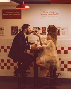 Engaged couple sharing burger in five guys fast food restaurant Burger Engagement Photos, Engagement Photos Fast Food, Grocery Store Wedding Photos, Mcdonalds Engagement Shoot, Fast Food Wedding Photos, Crazy Engagement Photos, Retro Diner Engagement Photos, Couple Diner Photoshoot