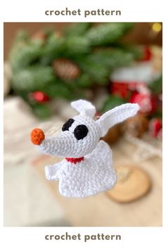 a crochet dog ornament hanging from a christmas tree with the words crochet pattern below it