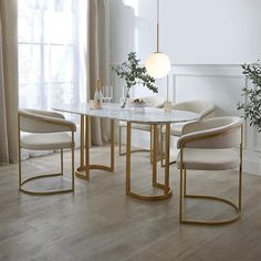 a dining room table with chairs and a vase on the table in front of it