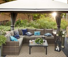 an outdoor living area with couches and tables