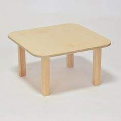 a small wooden table sitting on top of a white floor