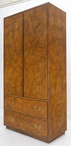 an old wooden armoire with two doors and drawers on one side, against a white background