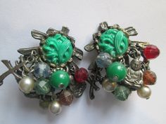 Nice Antique pot metal Chinese Buddha beaded dangle clip on earrings in good vintage condition and measures 1 1/2 inches. Vintage Metal Earrings With Dangling Beads, Silver Vintage Beaded Earrings With Dangling Beads, Vintage Metal Beaded Earrings With Dangling Beads, Vintage Silver Beaded Earrings, Vintage Metal Beaded Earrings, Vintage Metal Earrings With Round Beads, Vintage Green Earrings With Dangling Beads, Vintage Green Beaded Earrings, Vintage Green Beaded Earrings With Round Beads