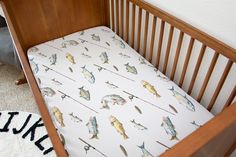 a baby crib with a fish print on it