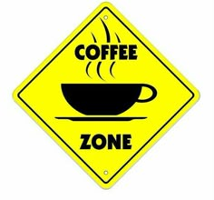 a yellow sign that says coffee zone with a cup of coffee on top of it