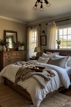 a large bed sitting in a bedroom next to a window with curtains on the windowsill