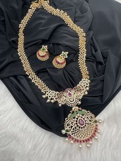 AD Red Green Multi Stone Peacock Pendent Golden Finish Long Necklace comes with Jhumkis Party wear golden finish American diamonds multi Color Necklace Pair it up with Saree Lehenga aur any Party wear dress. Necklace Length : Approx. 22 inches; Comes with adjustable back chain. Earring Length : .2 Inches Screw Back Ready to ship from Massachusetts, USA If you have any questions, Please let me know. Thank you!! Festive Bollywood Jewelry Sets With Peacock Design, Party Necklaces With Zari Work For Diwali, Zari Work Necklaces For Diwali Party, Party Kundan Necklaces With Zari Work, Party Kundan Necklace With Zari Work, Traditional Gold Sets With Peacock Design, Gold Sets With Peacock Design For Festive Season, Bollywood Party Necklace With Zari Work, Festive Peacock Design Jewelry Sets