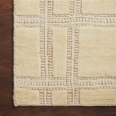 a white rug on top of a wooden floor