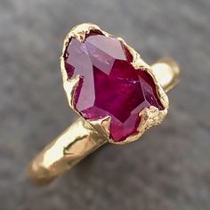 Amazing ruby sapphire partially faceted by my husband. I hand carved this ring in wax and cast it in recycled solid 18k yellow gold using the lost wax casting process. This one of a kind raw gemstone ring is a size 7 it can be resized. The sapphire stone measures about 10.5mm X 7mm. Throughout all time and history in every tribe and culture all around the world crystals, minerals and gemstones have used for healing, luck, divination, adornment vibrational medicine and so much more. Sapphire is a Gold Faceted Ruby Ring For Anniversary, Vibrational Medicine, 14k Yellow Gold Engagement Ring, Raw Gemstone Ring, Yellow Gold Engagement Ring, Sapphire Solitaire, Purple Sapphire, Wax Casting, Yellow Gold Engagement