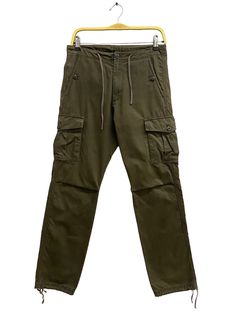 CODE : j/13/13 Vintage Blue Label United Arrow Army Green Pants Size 29 Blue Label Zipper Fly Cargo Pant Bluer Label Straightcut Utility Multipocket Pant Size on Tag :  Details Measurement  Waist : 29'inches Inseam : 31.5'inches Leg Opening : 15'inches Front Rise : 11'inches Thigh : 24'inches Knee : 16'inches Out Seam (Length) : 41'inches Hips : 40'inches Condition :  Great Vintage Condition.No Holes And No Stain.Please refer pictures detail.‼️ 📮 SHIPING > WE ARE USING DHL EXPRESS SHIPING ITS TAKE 3-5 ARRIVE.PLEASE DROP YOUR PHONE NUMBER AFTER PURCHASE.📮 Khaki Full-length Cargo Jeans, Khaki Full Length Jeans With Pockets, Full Length Khaki Jeans With Pockets, Khaki Tapered Leg Bottoms With Side Pockets, Green Cargo Pocket Straight Pants, Khaki Straight Cargo Jeans With Side Pockets, Green Cargo Straight Pants, Mid-rise Utility Cargo Pants With Pockets, Stretch Utility Jeans With Cargo Pockets