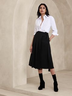 This midi skirt uses a pleated, asymmetrical front to inspire and is cut from a bonded twill fabric we love for its soft structure.  A-line fit.  Adjustable belt at wearer's left.  Side seam pockets.  Unlined.  A-line.  Midi length.  Model: Size 2, 5'10" (178cm). Work Skirt Outfits Women, Dark Academia Office Wear, Button Down Skirt Outfits, Midi Skirt Outfit Work, Kilt Fashion, Black Midi Skirt Outfit, Office Skirt Outfit, Blue Skirt Outfits, A Line Skirt Outfits