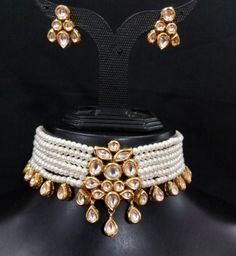 Product Description: * Royal kundan choker set, pastel kundan choker, green kundan choker, white kundan choker, Indian kundan chokers, simple kundan, sabyasachi *  The base metal color is Gold tone studded with kundan along with Beads work on it. * This Jewelry set would add more charms to your beautiful jewelry collection and would surely bring lots of compliments . * Note:- This is an artificial Jewelry Set. * Care Instructions: Keep it dust-free & dirt free in a plastic pouch. Remember to app Elegant White Chandbali Choker, Traditional White Choker As A Gift, Traditional White Choker For Gift, White Temple Jewelry Choker For Festivals, White Kundan Choker Necklace In Temple Jewelry Style, Elegant Kundan Choker Necklace For Diwali, White Temple Jewelry Choker For Celebrations, White Temple Jewelry Style Choker For Celebrations, White Meenakari Choker For Festivals