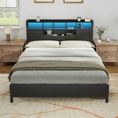 a bedroom with a bed, night stand and two nightstands on either side of the bed