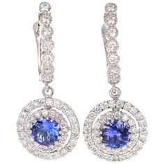 These beauties have 2 Round Cut Tanzanites that weigh 1.51 Carats and 91 Round Cut Diamonds that weigh 1.68 Carats. The total carat weight of the earrings are 3.19 Carats. (Clarity: VS2, Color: F) They are curated in 14 Karat White Gold and weigh approximately 6.6 grams The earrings are 1.25 inches long. White Gold Tanzanite Earrings With Brilliant Cut, Tanzanite Round Wedding Earrings, Round Tanzanite Wedding Earrings, Tanzanite Earrings With Prong Setting, Tanzanite Round Earrings For Wedding, Round Tanzanite Earrings For Weddings, Luxury Round Tanzanite Earrings, Classic Round Tanzanite Earrings, Elegant Tanzanite Round Earrings