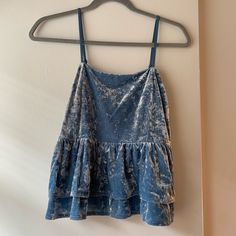 Brand: American Eagle Size: M Color: Blue American Eagle Velvet Tiered Babydoll Camisole With Smocked Back And Adjustable Straps. New With Tags. Blue Spaghetti Strap Vest Top, Blue Ruffled Cami Tank Top, Blue Spaghetti Strap Top With Ruffles, Blue Ruffled Top With Spaghetti Straps, Blue Ruffled Spaghetti Strap Top, Spring Blue Camisole With Ruffles, Blue Ruffled Camisole For Spring, Blue Ruffled Sleeveless Camisole, Blue Cotton Tank Top With Ruffles