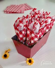 red and white gingham paper flowers in a square container with sunflowers on the side