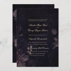 an elegant black and gold wedding card with purple flowers on the inside, in front of a marble background