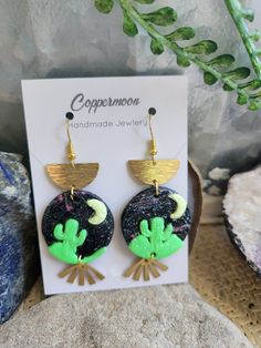 Beautiful boho mixed media earrings! black light sensitive, 🌵 and moonlight! Adjustable Funky Earrings For Festivals, Black Dangle Jewelry For Summer, Handmade Black Moon-shaped Earrings, Handmade Black Moon Earrings, Artsy Green Earrings For Party, Artistic Black Dangle Earrings, Green Artsy Earrings For Party, Artistic Black Nickel-free Earrings, Funky Handmade Black Jewelry