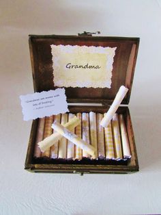 an open box with some candles in it and a note on the inside that says grandma