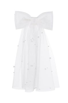 a white dress with a large bow on the front and small bows on the back